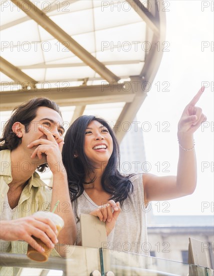 Couple pointing and looking up