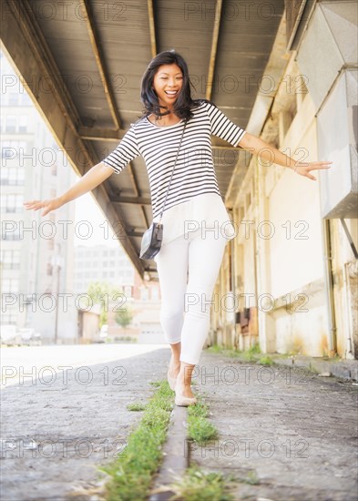 Chinese woman walking on urban street