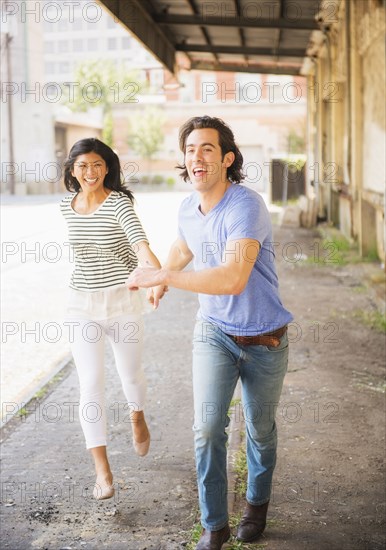 Couple running on urban street