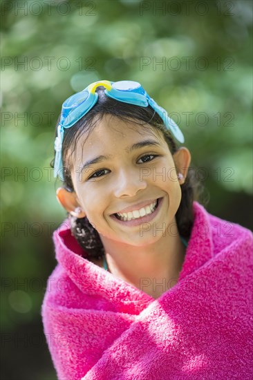 Mixed race girl wrapped in towel