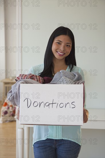 Chinese woman holding donations box