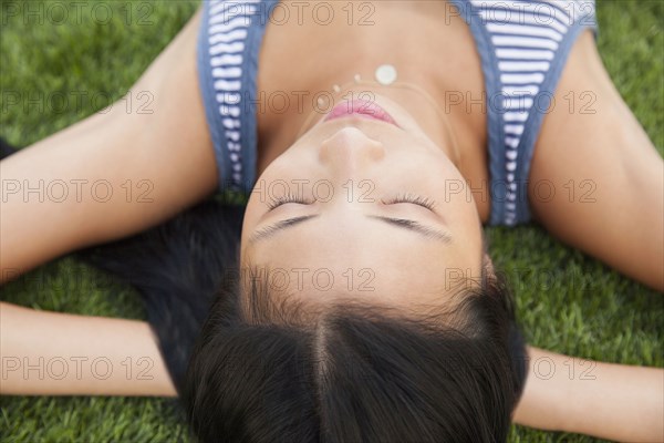 Chinese woman laying in grass