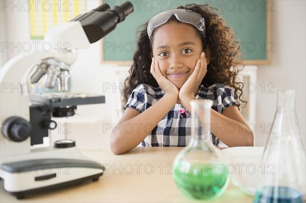 Mixed race student smiling in chemistry lab
