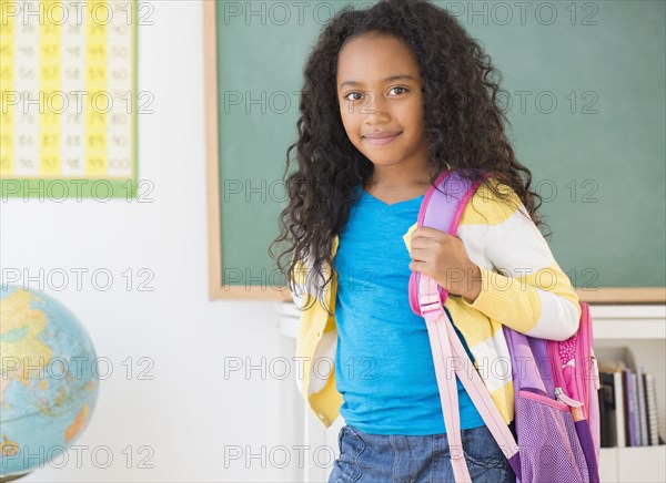Mixed race student smiling in classroom