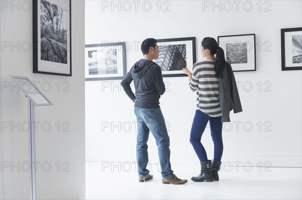 Couple admiring art in gallery