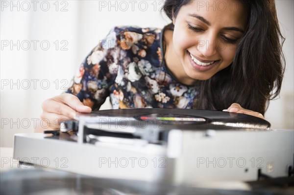 Close up of Asian woman using record player