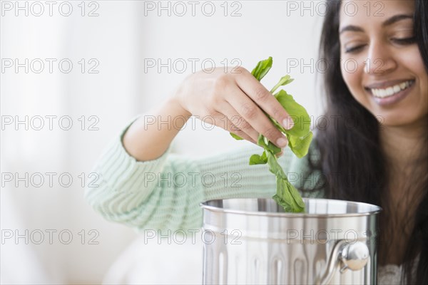 Asian woman composting lettuce