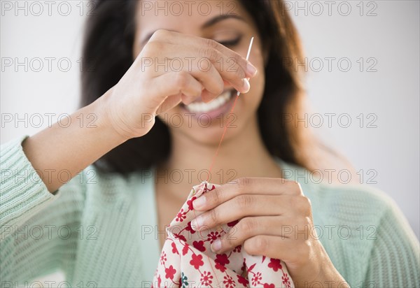 Close up of Asian woman sewing