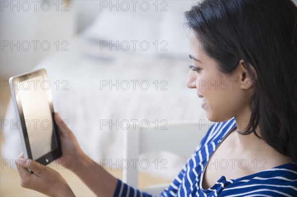 Asian woman using digital tablet