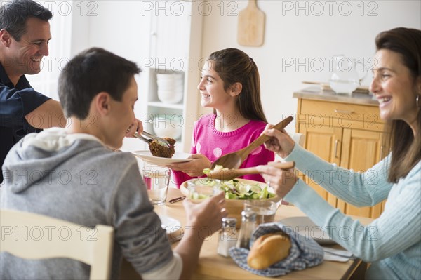 Caucasian family eating at table
