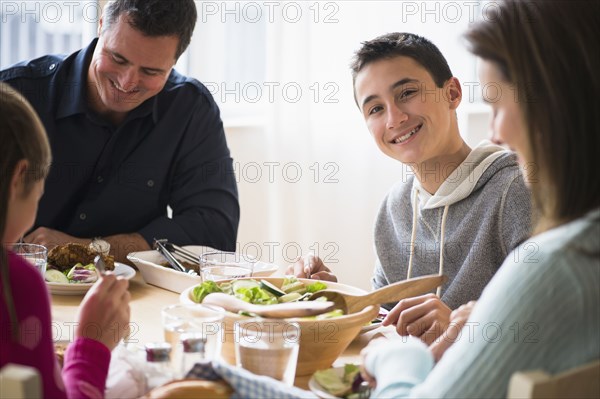 Caucasian family eating at table