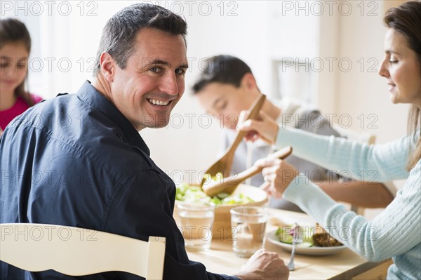 Caucasian family eating at table