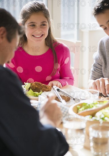 Caucasian family eating at table