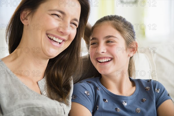 Close up of Caucasian mother and daughter laughing