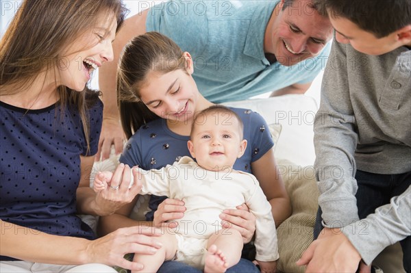 Caucasian family playing with baby girl