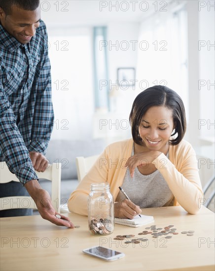 Couple counting savings at table