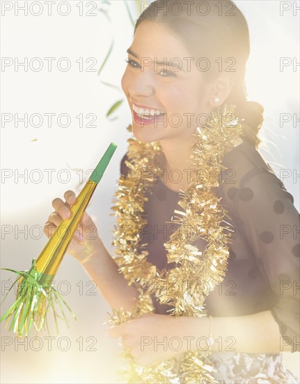 Smiling Hispanic woman celebrating New year's Eve