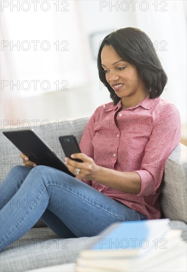 African American using cell phone and digital tablet