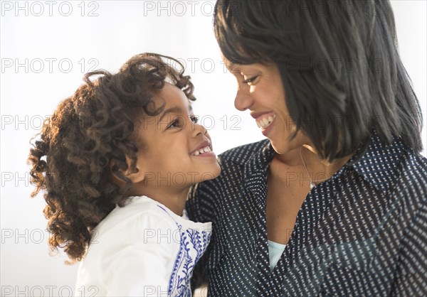 African American mother and daughter hugging and smiling