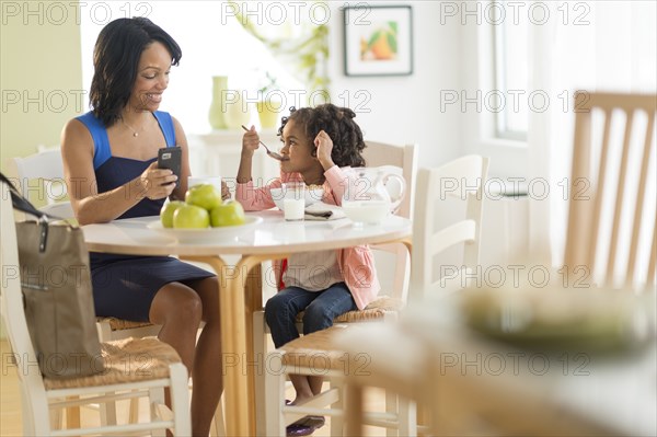 African American mother and daughter at breakfast table