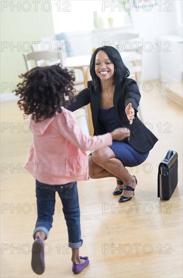 African American girl running to greet mother