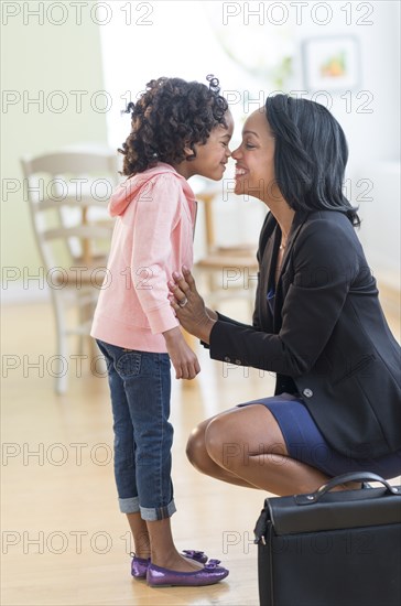 Black mother and daughter rubbing noses