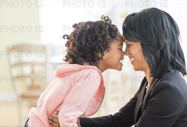 Black mother and daughter rubbing noses
