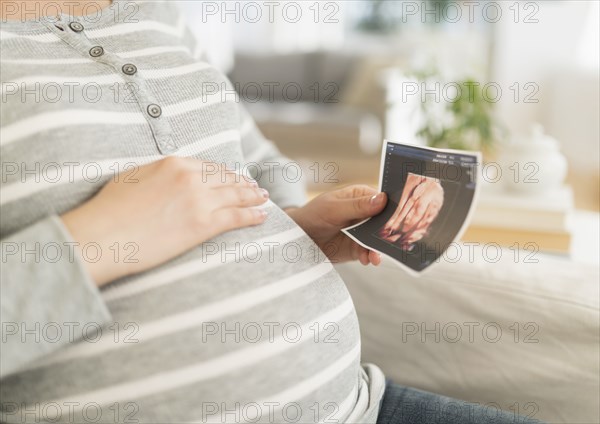 Pregnant Japanese woman holding ultrasound image