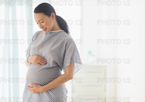 Pregnant Japanese woman in hospital gown