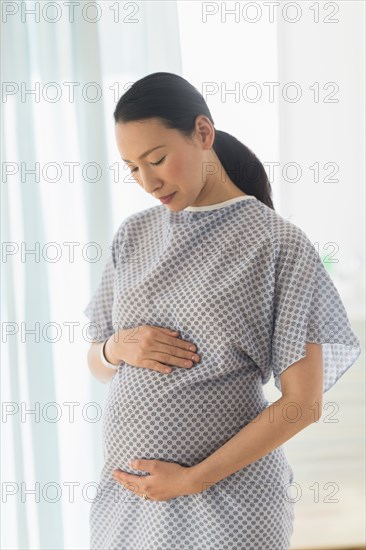 Pregnant Japanese woman in hospital gown