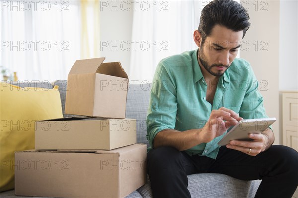 Mixed race man using digital tablet and moving