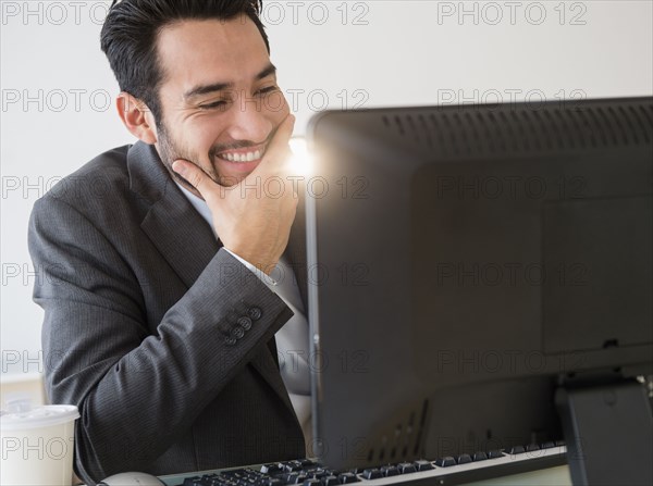 Mixed race businessman working in office