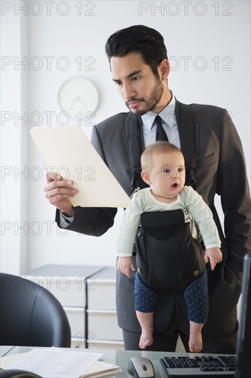 Businessman working with baby in office