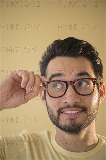 Mixed race man wearing glasses