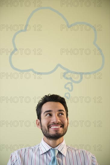 Mixed race businessman with thought bubble