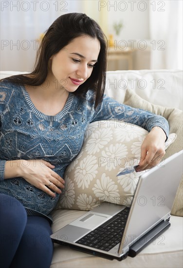 Pregnant Caucasian woman shopping online