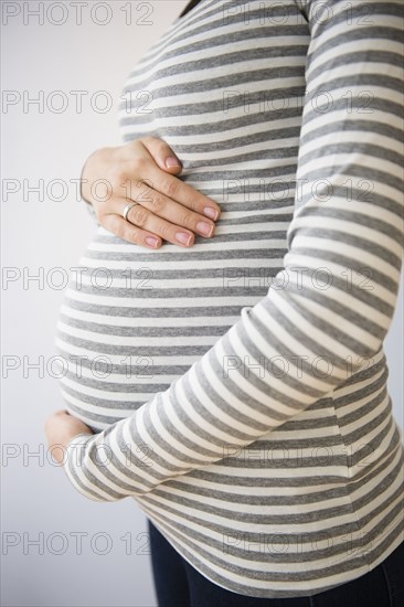 Pregnant Caucasian woman holding her belly