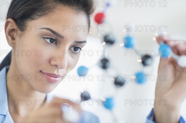 Hispanic scientist examining molecular model