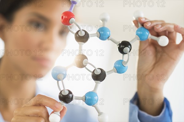 Hispanic scientist examining molecular model