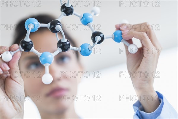 Hispanic scientist examining molecular model