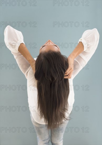 Hispanic woman with long hair leaning back