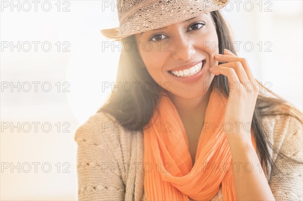 Hispanic woman in fedora and scarf