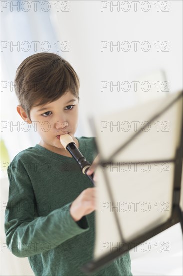 Hispanic boy practicing recorder