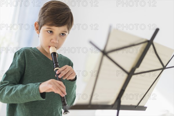 Hispanic boy practicing recorder