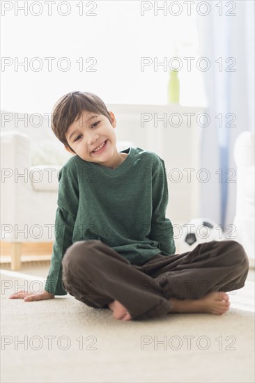 Hispanic boy smiling in living room