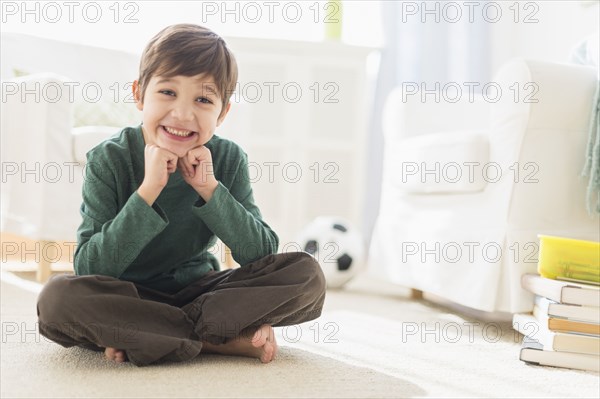 Hispanic boy smiling in living room