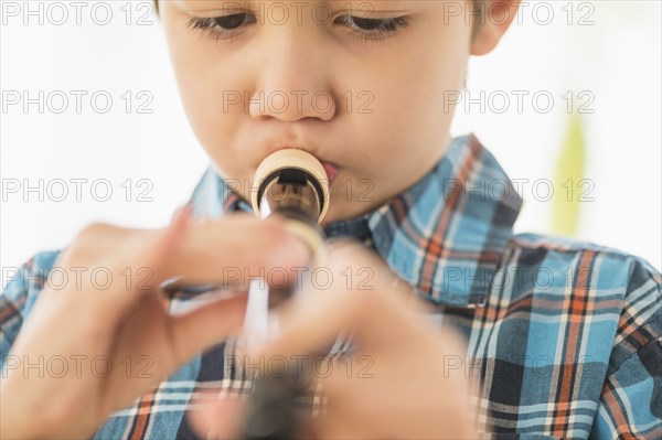 Hispanic boy practicing recorder