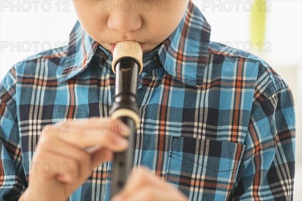 Hispanic boy practicing recorder