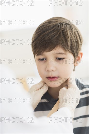 Hispanic boy getting a checkup at doctor's office