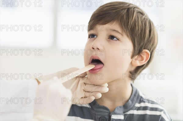 Hispanic boy getting a check up at doctor's office